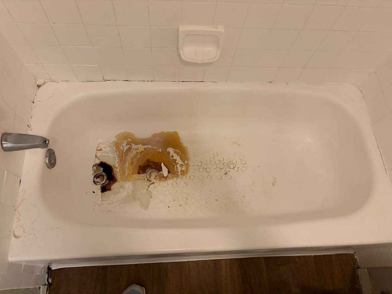 Bathtub — overhead view showing rusted drain